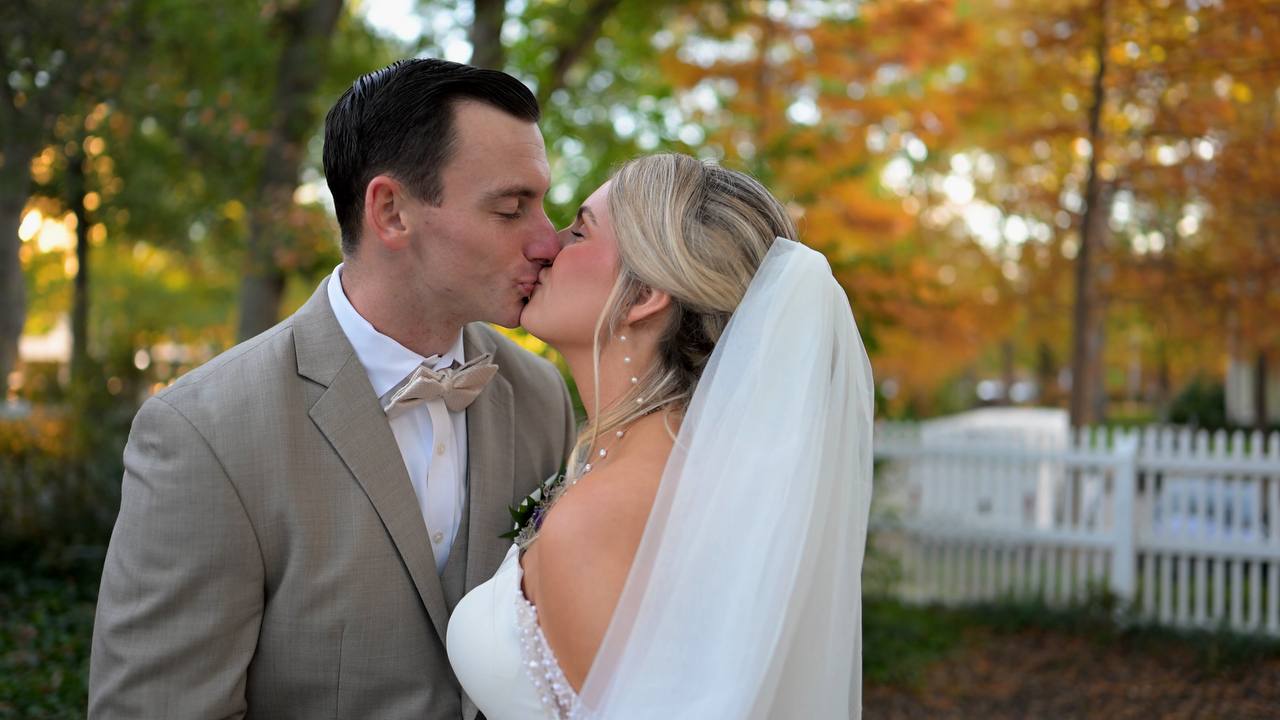 Chloe and Dan kissing outdoors on their wedding day